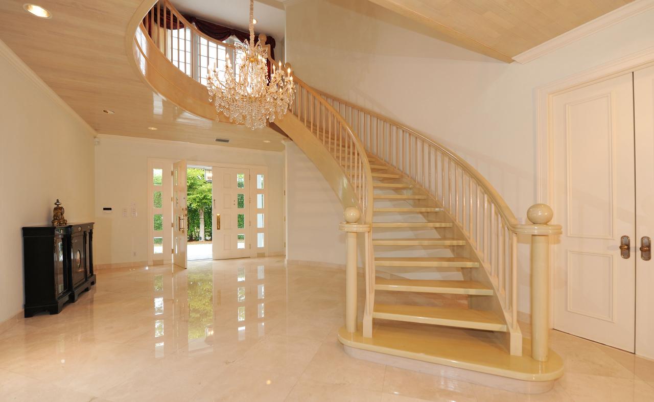 202 Indian Road Palm Beach, FL 33480 - Photo 8 of 24 a view of staircase with lots of frames on wall and a chandelier