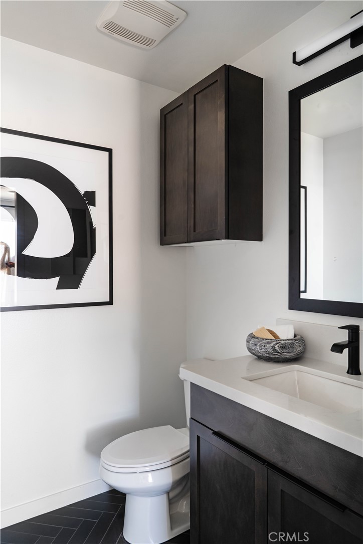 1902 West Sycamore Drive Compton, CA 90220 - Photo 13 of 15 a bathroom with a sink a toilet and mirror