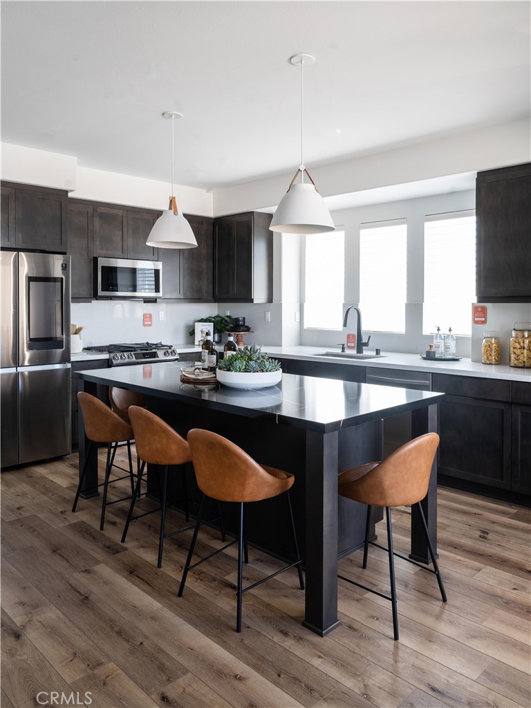 1902 West Sycamore Drive Compton, CA 90220 - Photo 4 of 15 a kitchen with a sink cabinets and dining table