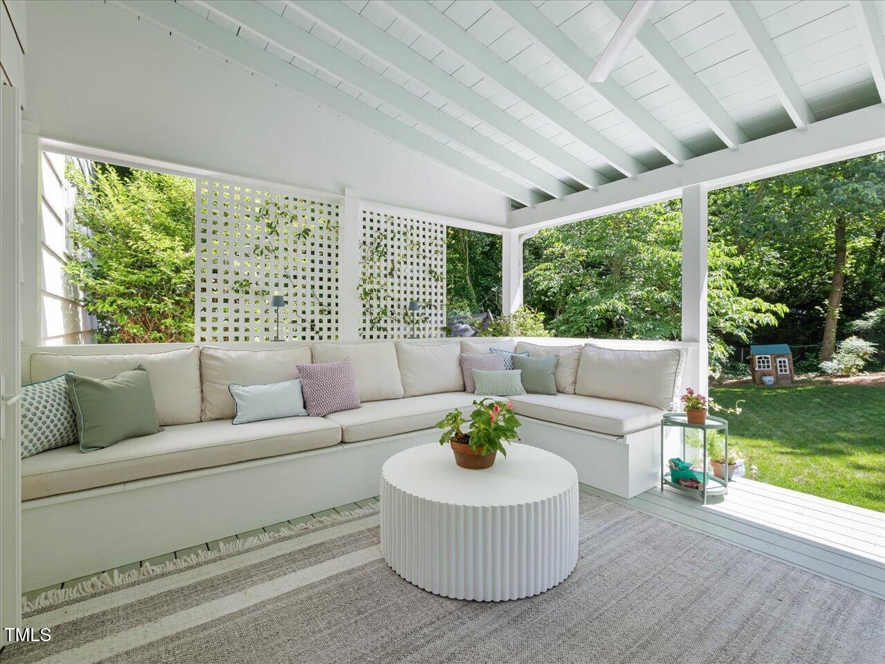 4112 Rowan Street Raleigh, NC 27609 - Photo 12 of 35 a living room with furniture and a large window with garden view