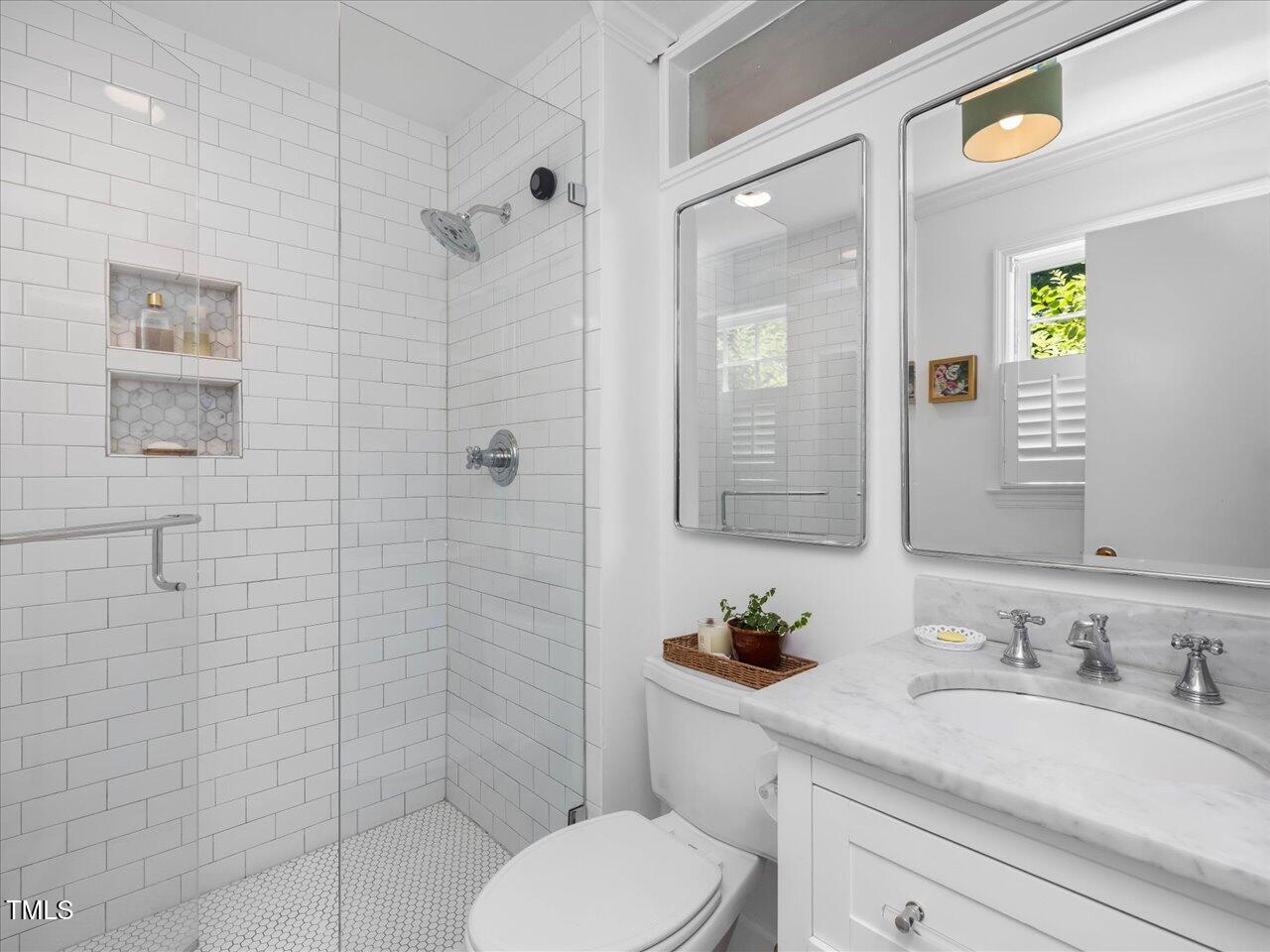 4112 Rowan Street Raleigh, NC 27609 - Photo 16 of 35 a bathroom with a granite countertop toilet sink shower and mirror