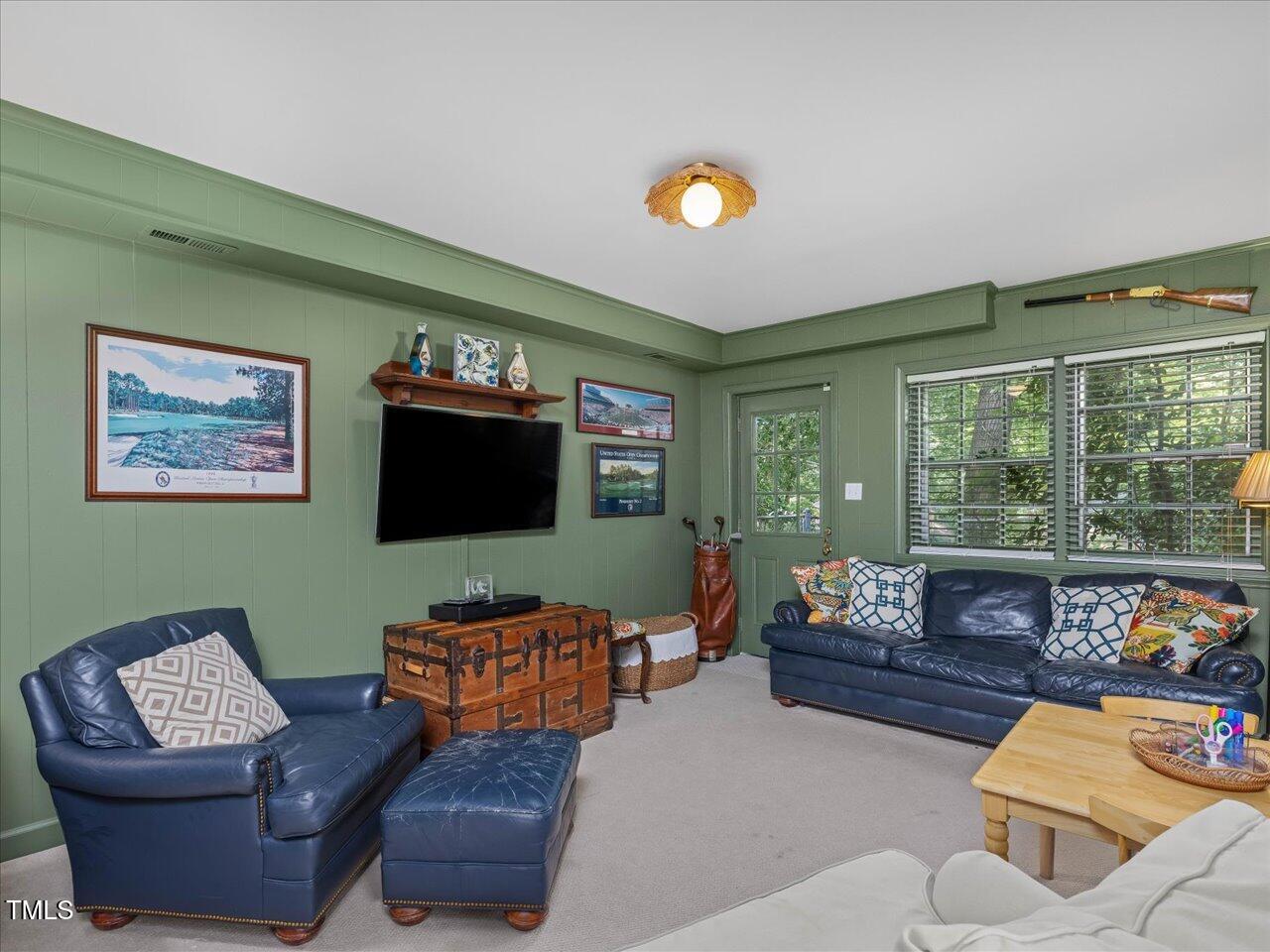 4112 Rowan Street Raleigh, NC 27609 - Photo 20 of 35 a living room with furniture and a flat screen tv