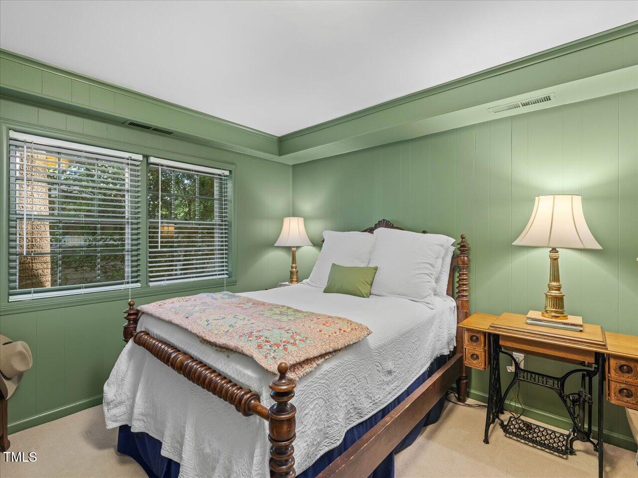 4112 Rowan Street Raleigh, NC 27609 - Photo 23 of 35 a bedroom with a bed and a table in it