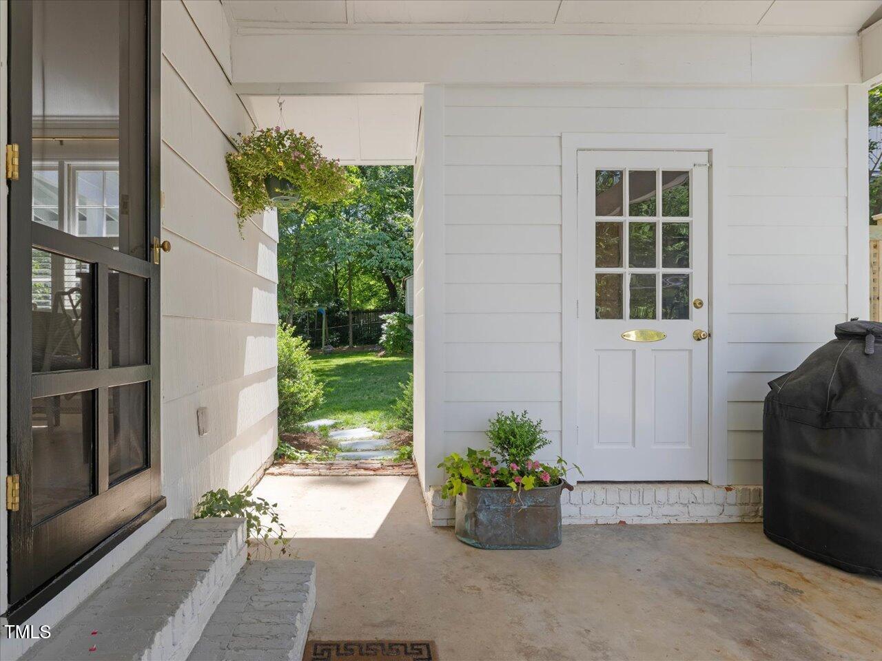 4112 Rowan Street Raleigh, NC 27609 - Photo 26 of 35 a view of a entryway door with flower in front of house