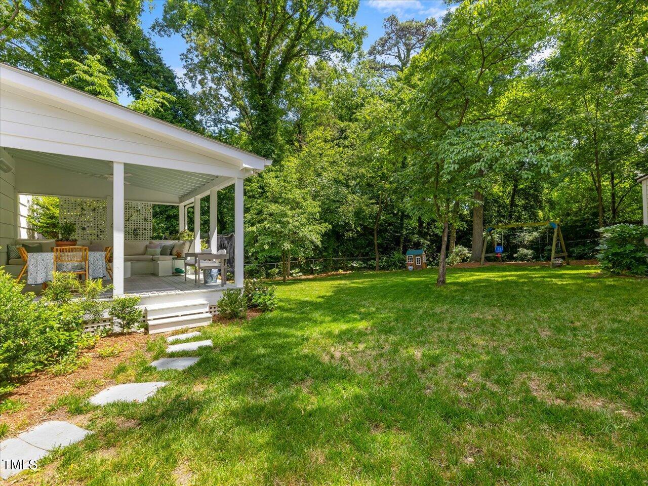 4112 Rowan Street Raleigh, NC 27609 - Photo 27 of 35 a view of a house with a backyard and a patio
