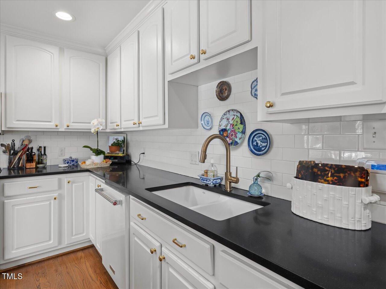 4112 Rowan Street Raleigh, NC 27609 - Photo 10 of 35 a kitchen with a sink and cabinets