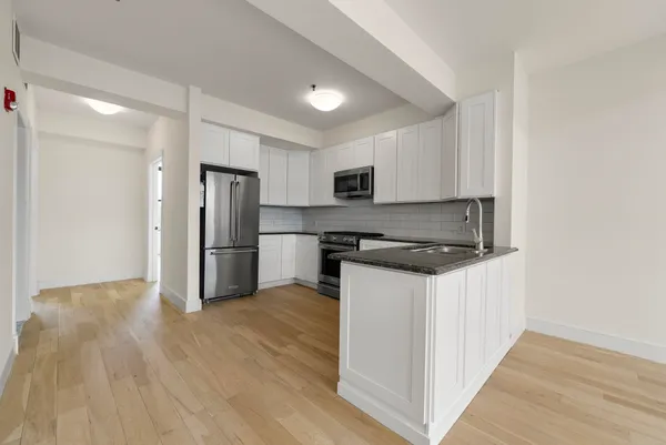 a kitchen with a refrigerator stove and microwave