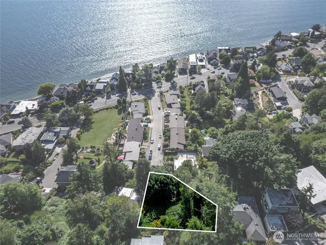 an aerial view of a residential houses with outdoor space and street view