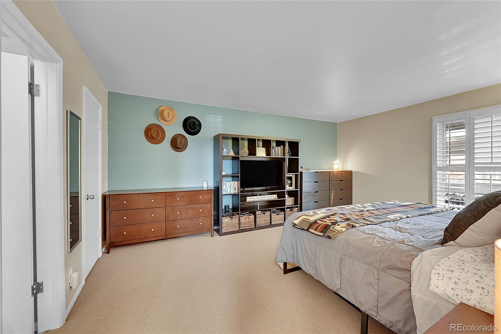 6495 East Happy Canyon Road, Unit 174 Denver, CO 80237 - Photo 13 of 32 a bedroom with a bed and furniture