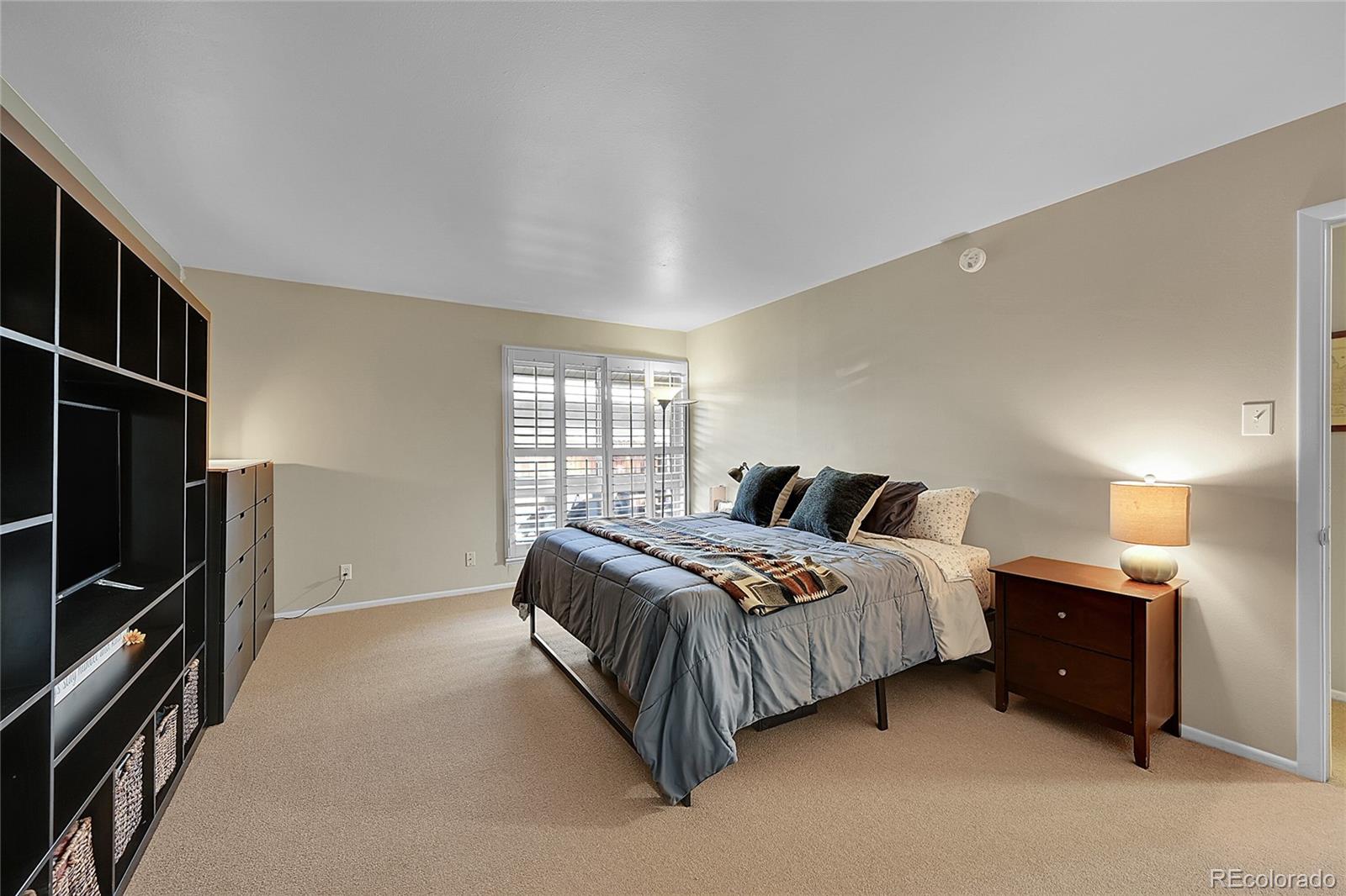 6495 East Happy Canyon Road, Unit 174 Denver, CO 80237 - Photo 14 of 32 a spacious bedroom with a bed and a window