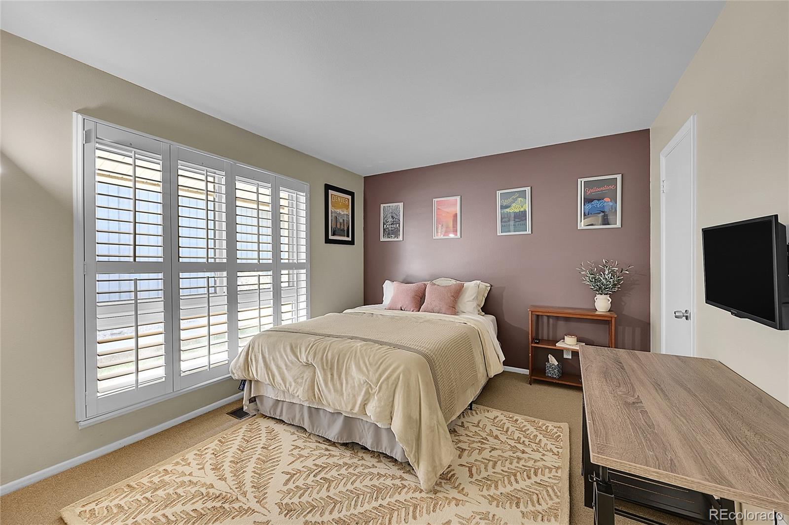 6495 East Happy Canyon Road, Unit 174 Denver, CO 80237 - Photo 18 of 32 a bedroom with a bed and a flat screen tv