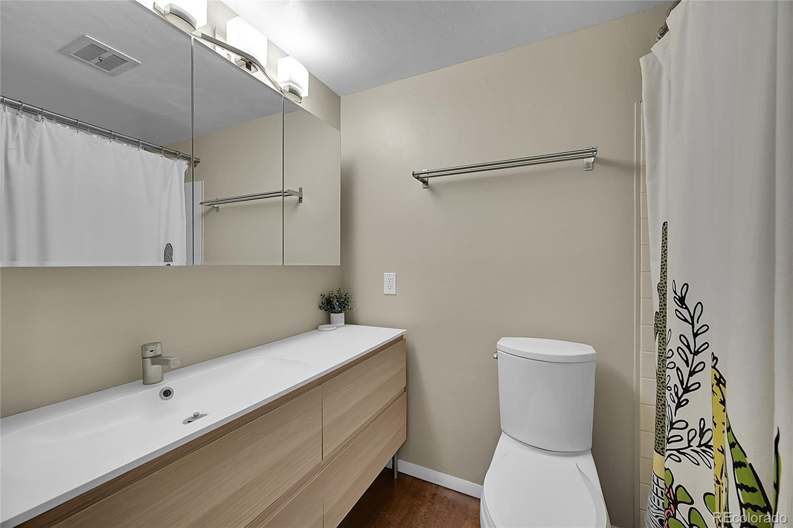 6495 East Happy Canyon Road, Unit 174 Denver, CO 80237 - Photo 20 of 32 a bathroom with a sink a toilet and shower