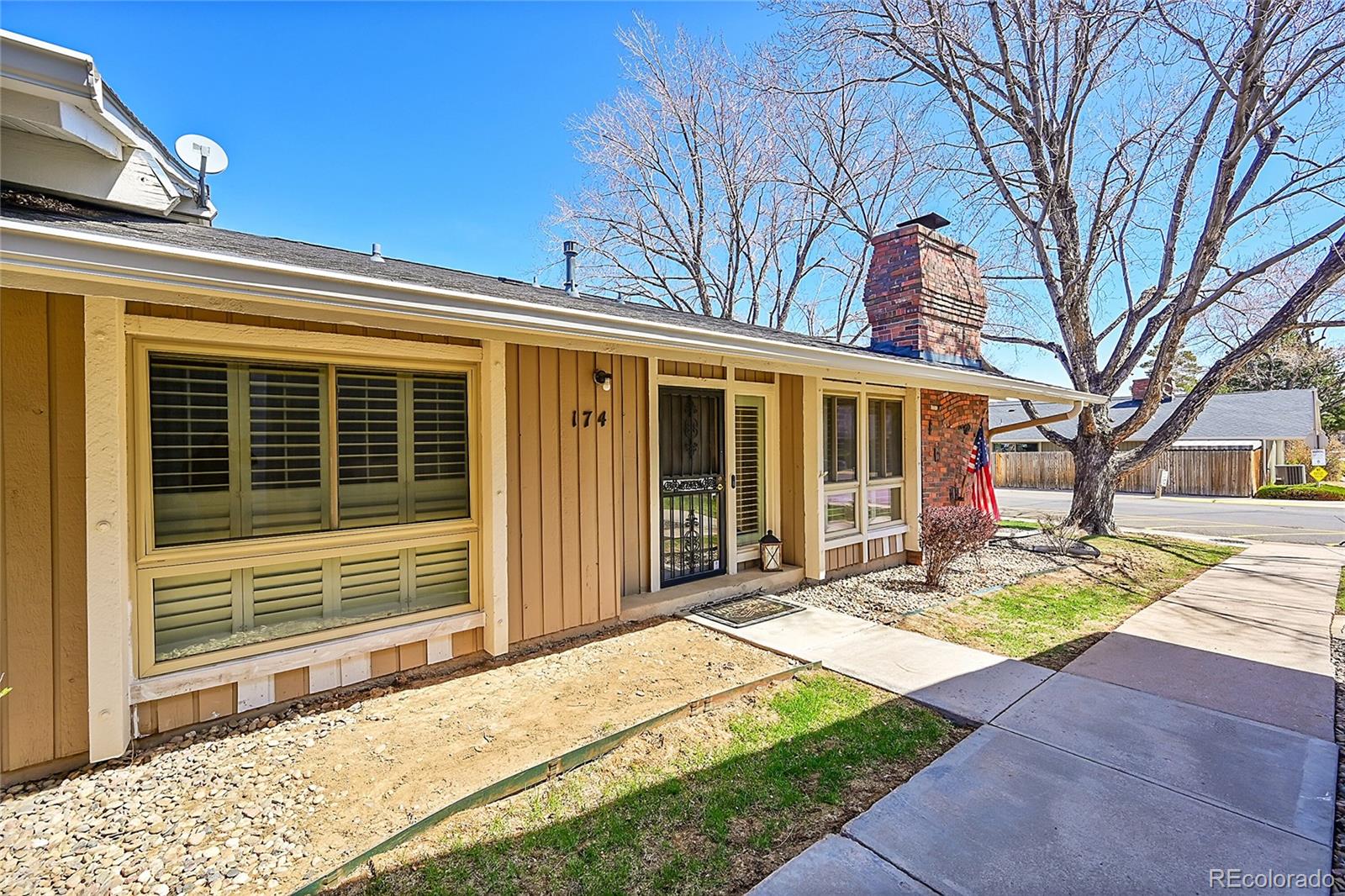 6495 East Happy Canyon Road, Unit 174 Denver, CO 80237 - Photo 2 of 32 a view of a house with a large window and a large tree