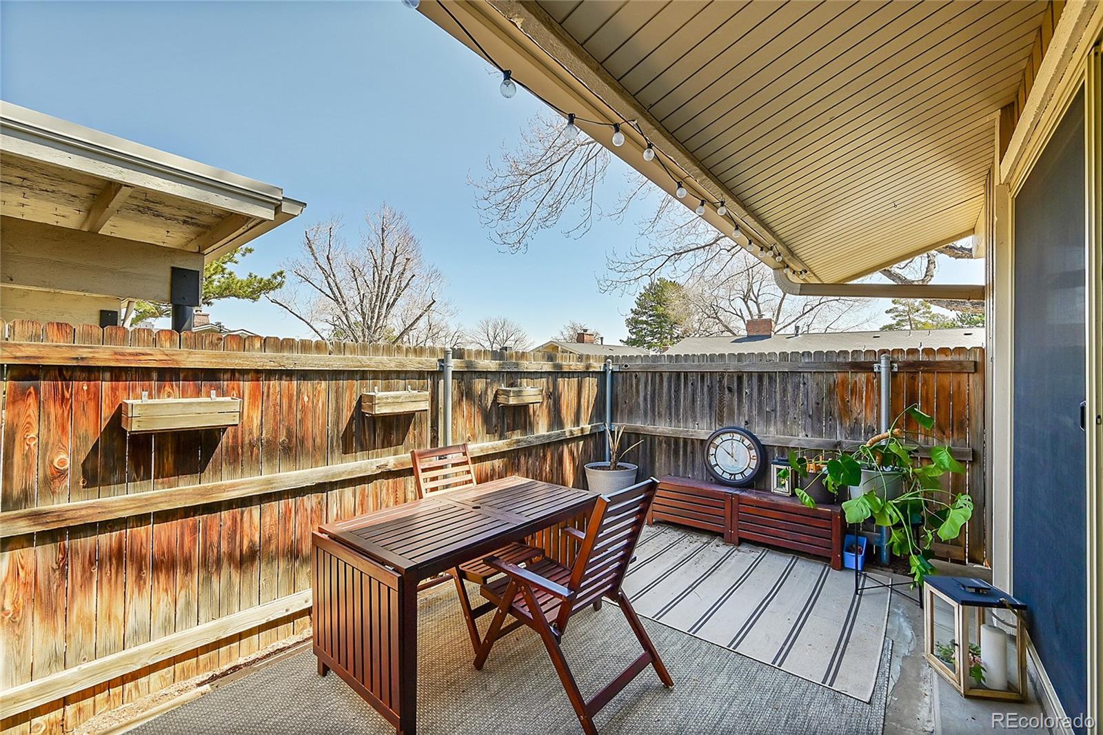 6495 East Happy Canyon Road, Unit 174 Denver, CO 80237 - Photo 21 of 32 a balcony with wooden floor table and chairs