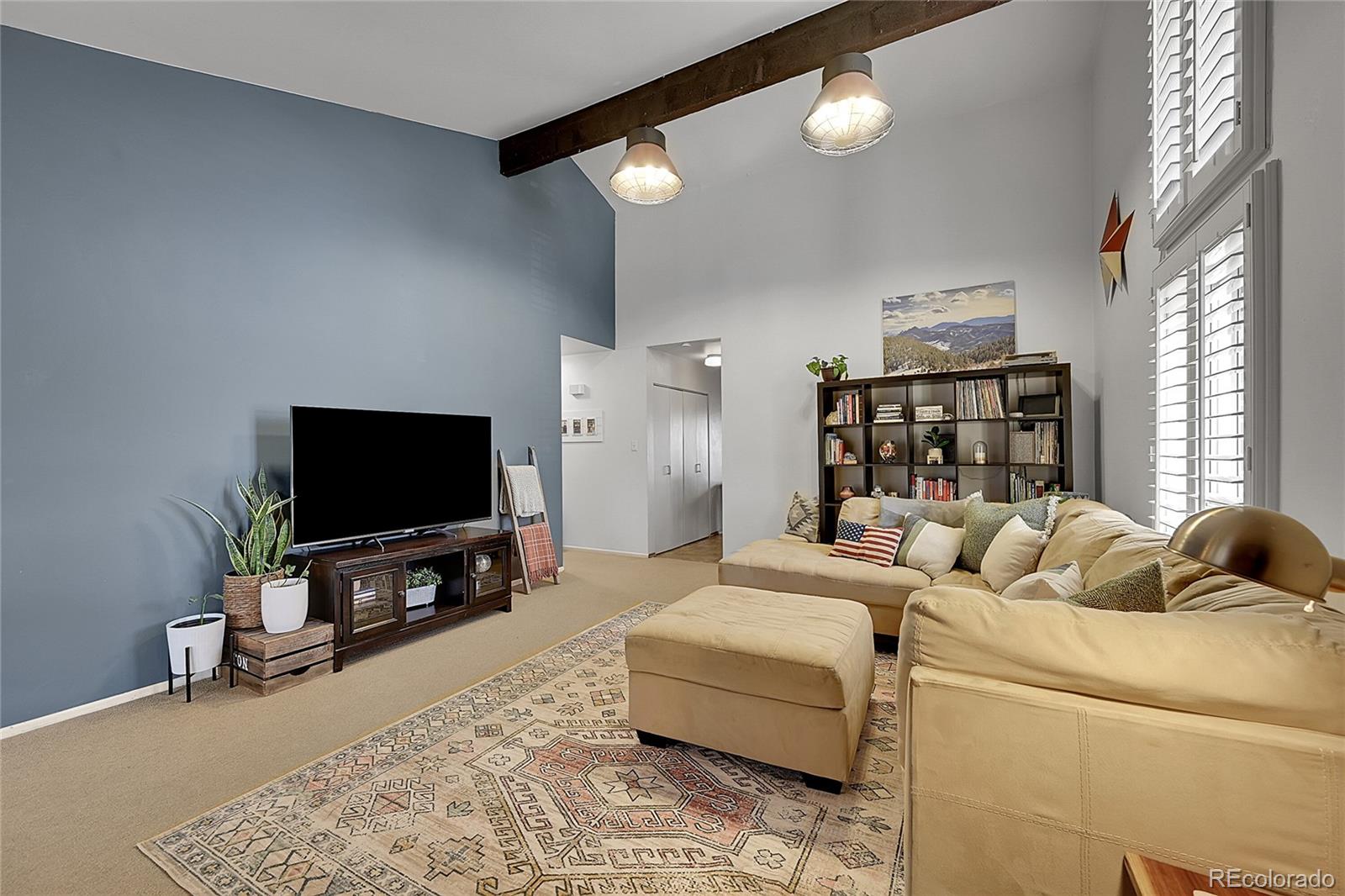 6495 East Happy Canyon Road, Unit 174 Denver, CO 80237 - Photo 5 of 32 a living room with furniture and a flat screen tv