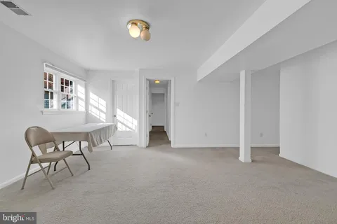 a view of a livingroom with furniture and a window