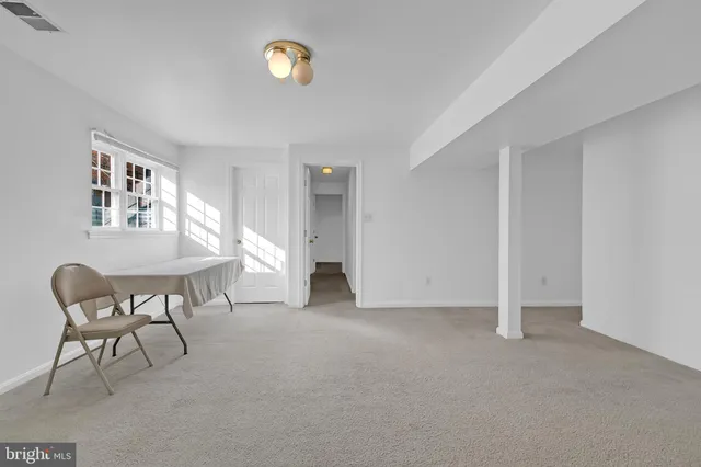 a view of a livingroom with furniture and a window
