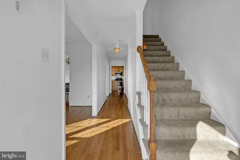 a view of a hallway with wooden floor and entryway
