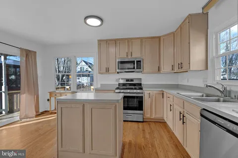 a kitchen with granite countertop a sink stove and cabinets