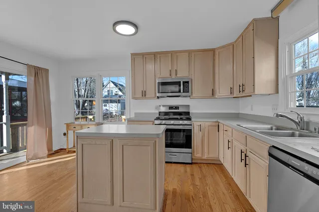 a kitchen with granite countertop a sink stove and cabinets