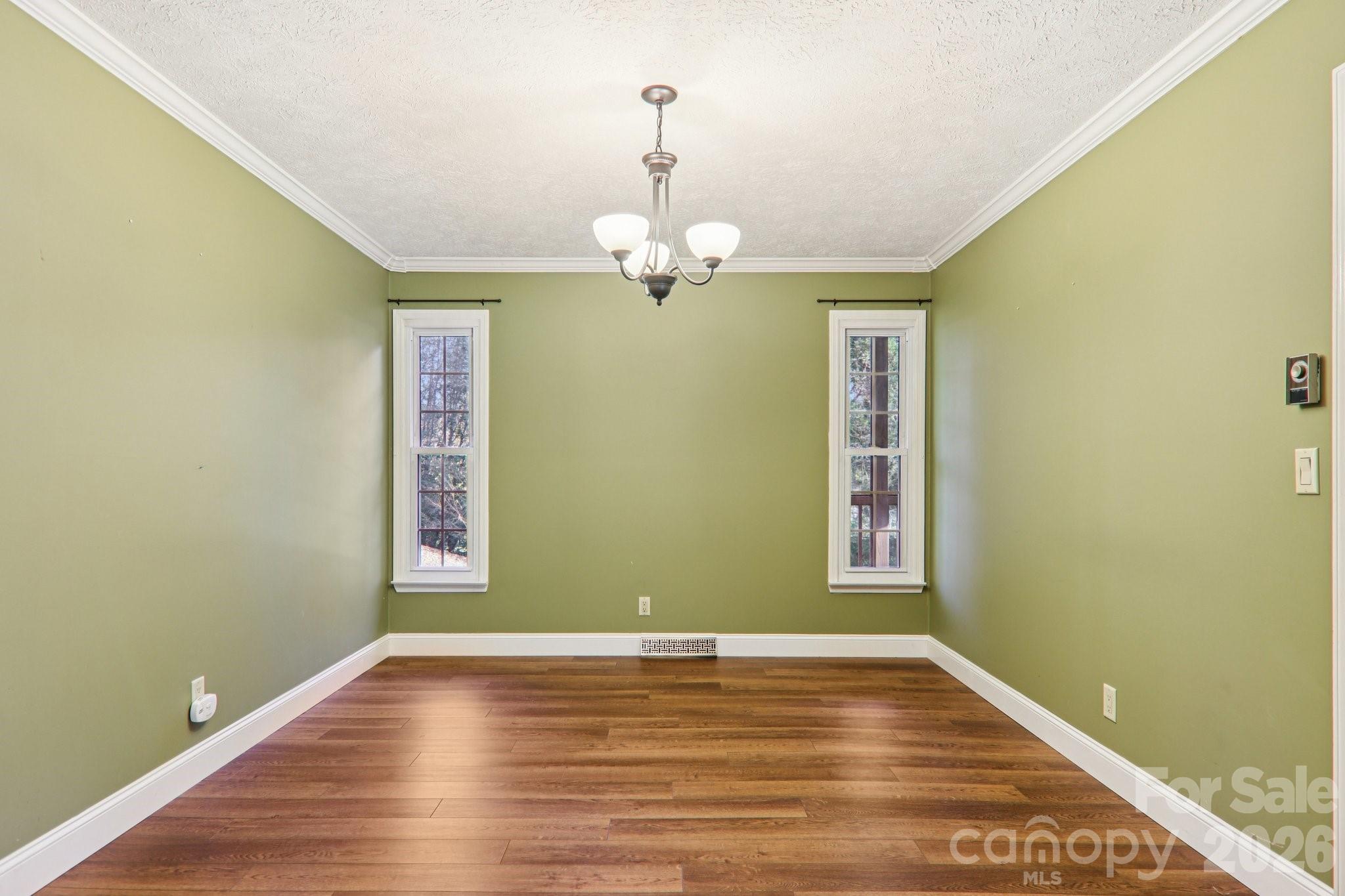 261 Eastview Road Brevard, NC 28712 - Photo 11 of 15 a view of a room with wooden floor window and a ceiling fan