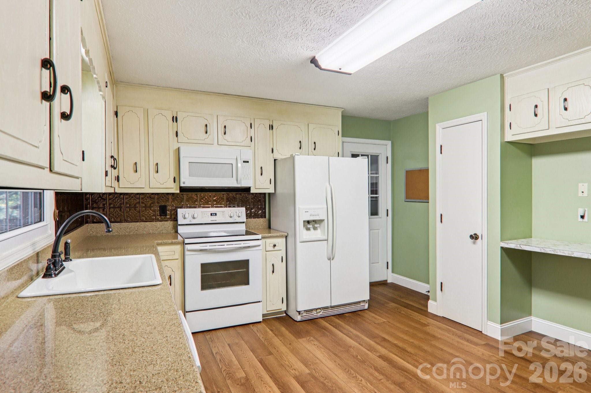 261 Eastview Road Brevard, NC 28712 - Photo 15 of 15 a kitchen with stainless steel appliances a refrigerator sink and cabinets