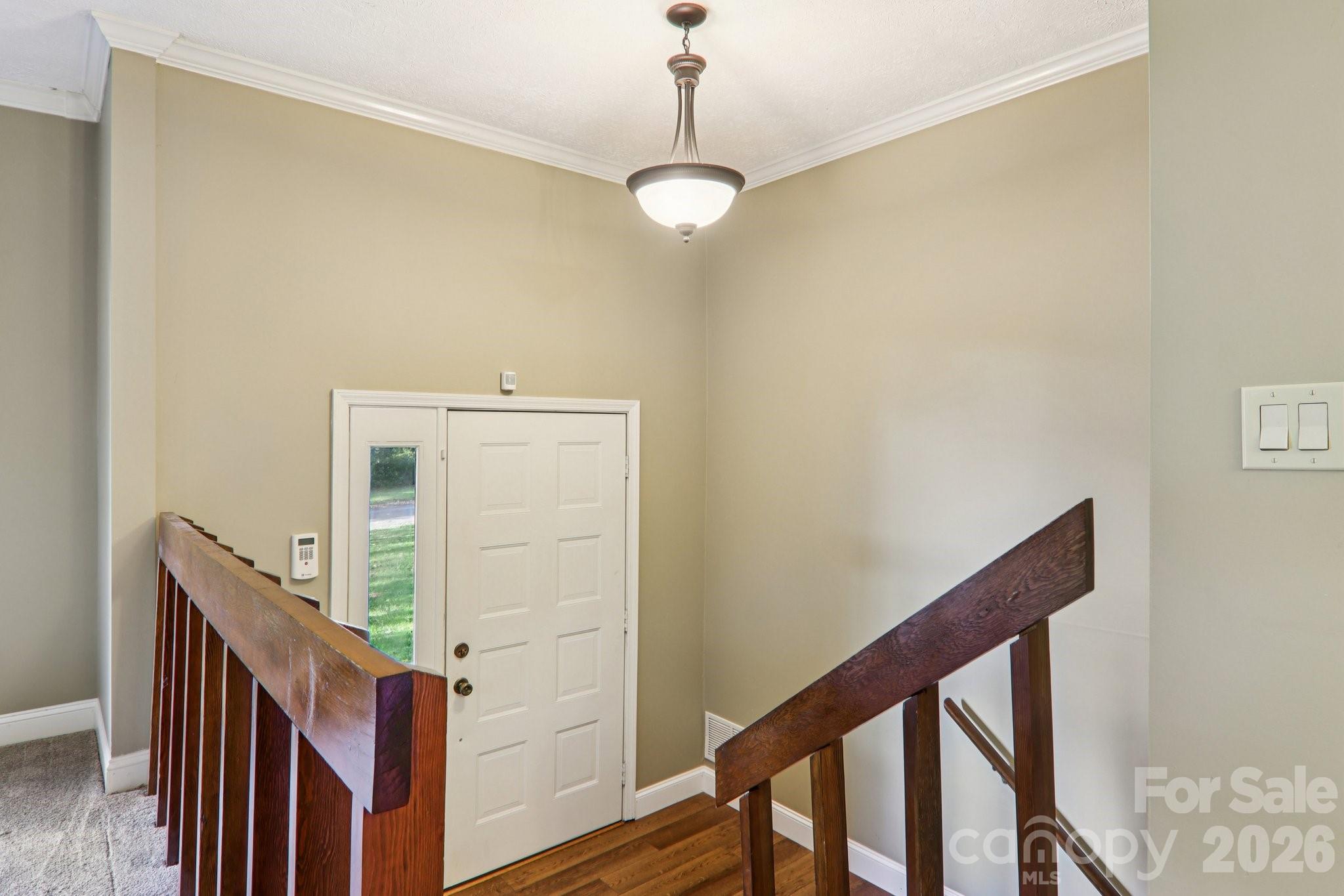 261 Eastview Road Brevard, NC 28712 - Photo 5 of 15 a view of a hallway with wooden floor and staircase
