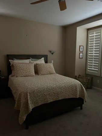 a bedroom with a bed and window