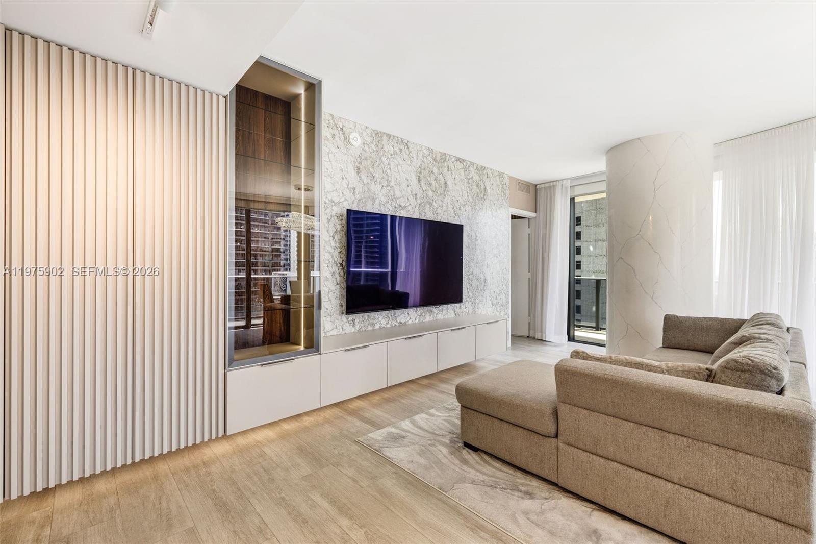 a living room with furniture and a flat screen tv