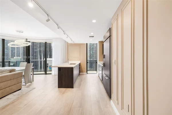 a large room with wooden floor and windows