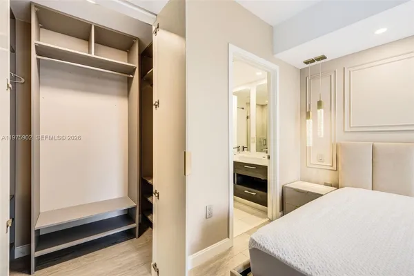 a bedroom with a bed and a dresser