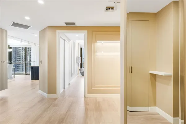 a view of a hallway with wooden floor