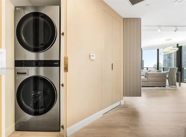 a view of a hallway with washer and dryer