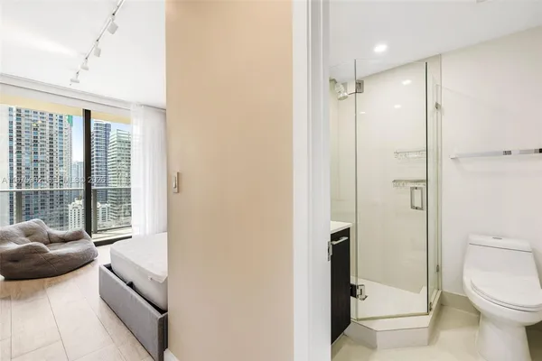 a bathroom with a tub shower and toilet