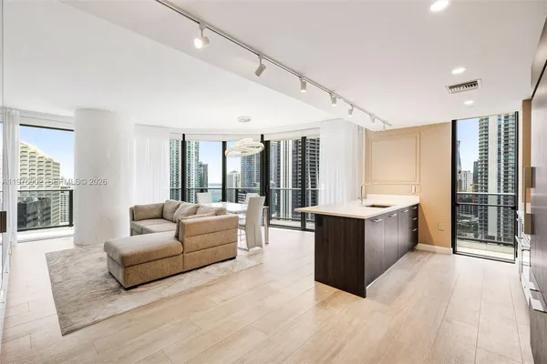 a living room with furniture and large windows