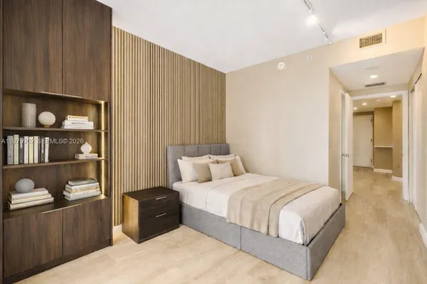 a bedroom with a bed and walk in closet