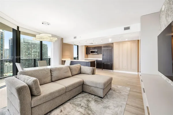 a living room with furniture and a large window
