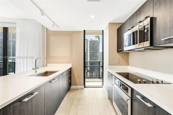 a kitchen with stainless steel appliances granite countertop a sink and a stove