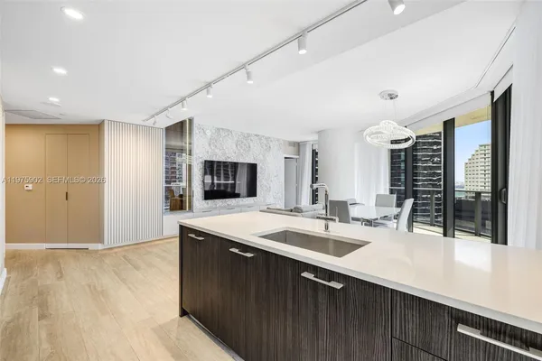 a large kitchen with kitchen island a sink stainless steel appliances and cabinets