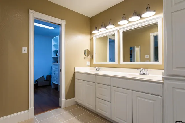 a bathroom with a double vanity sink and a mirror