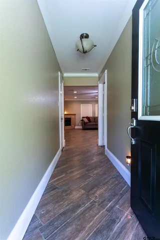 a view of empty room with wooden floor