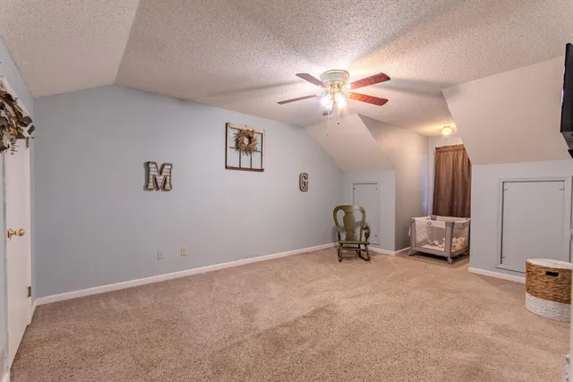 a view of a livingroom with furniture and a ceiling fan