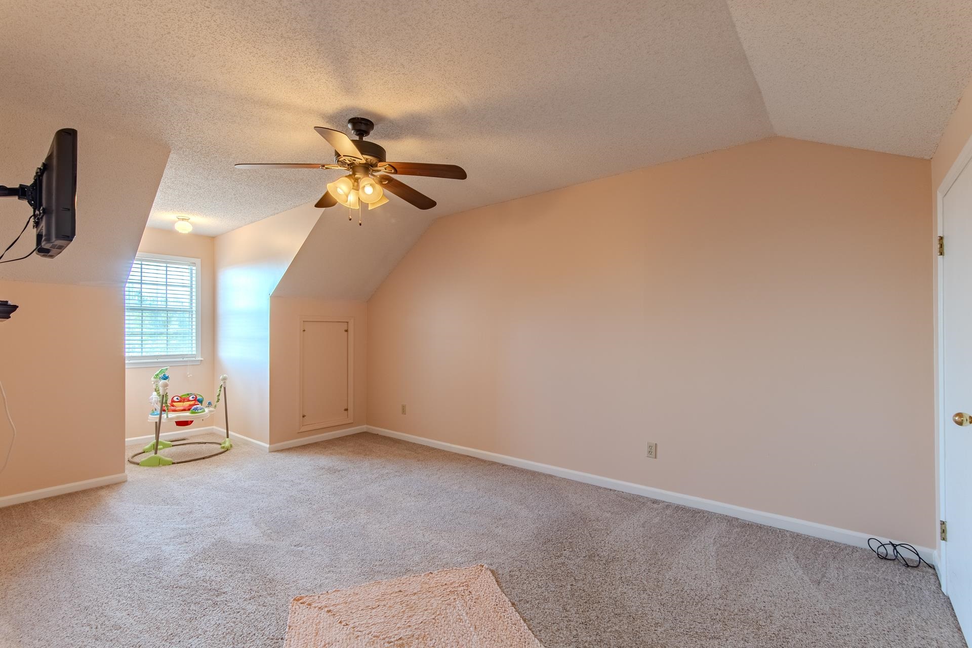 345 Dancer Road Selmer, TN 38375 - Photo 19 of 24 Bonus room featuring carpet flooring, vaulted ceiling, a textured ceiling, and a ceiling fan
