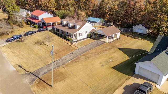a aerial view of a house with a backyard