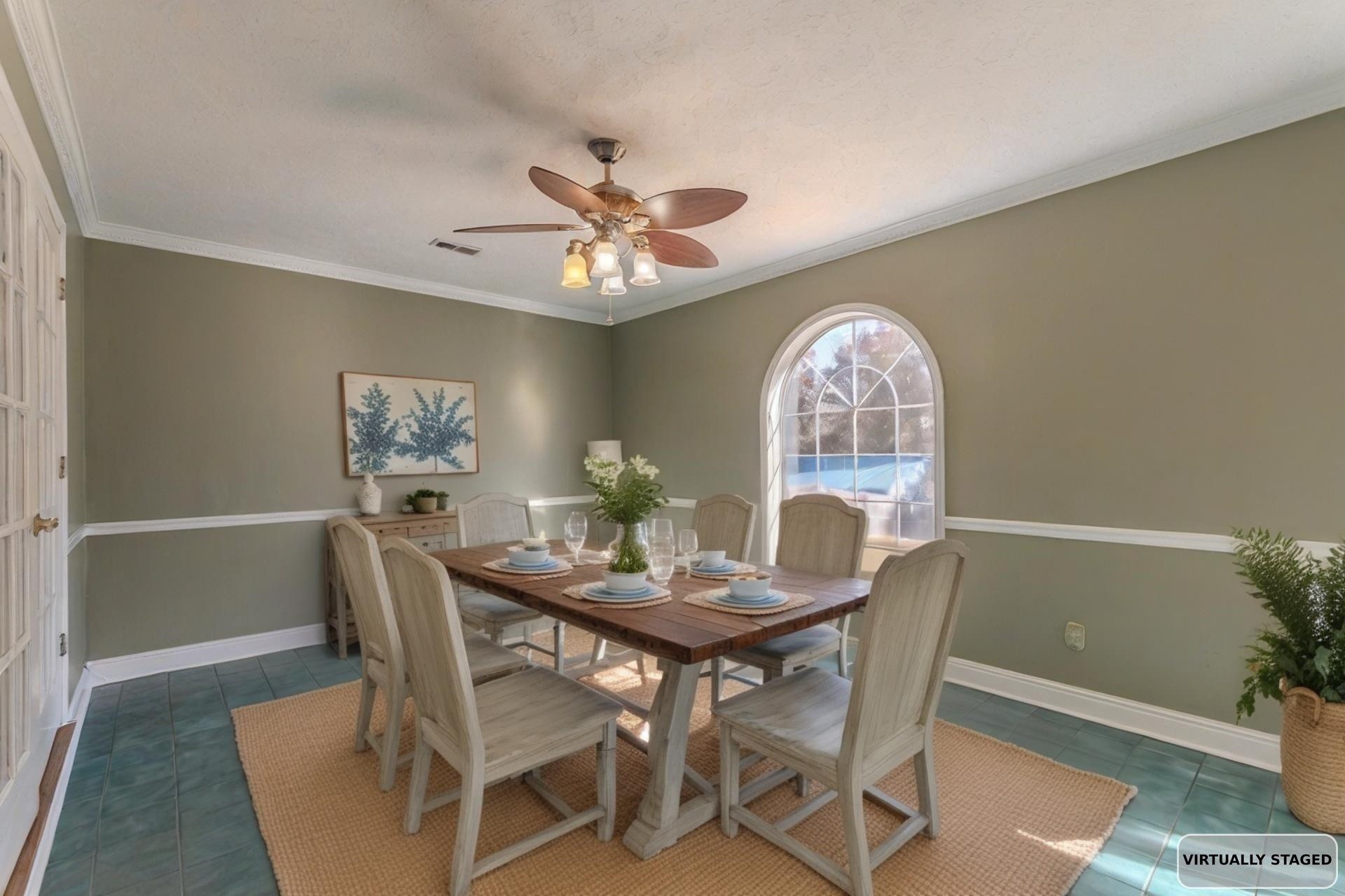 345 Dancer Road Selmer, TN 38375 - Photo 8 of 24 Dining area with crown molding, dark tile patterned flooring, and a ceiling fan
