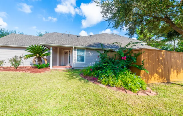 a front view of a house with garden