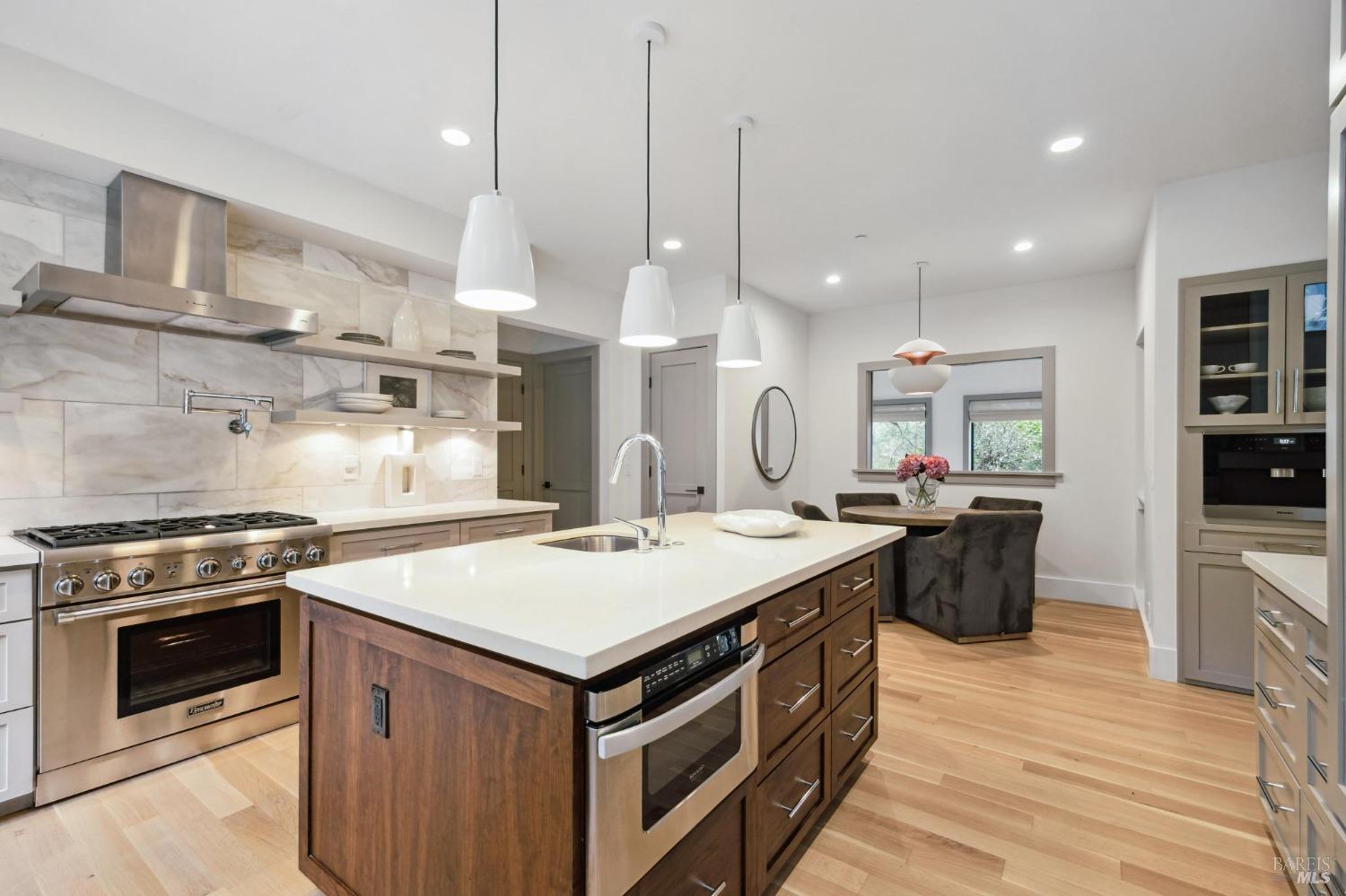 23 Janes Street Mill Valley, CA 94941 - Photo 9 of 32 a kitchen with kitchen island a stove a sink a center island and wooden floor