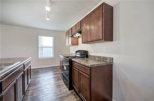 a kitchen with stainless steel appliances granite countertop a stove and a sink