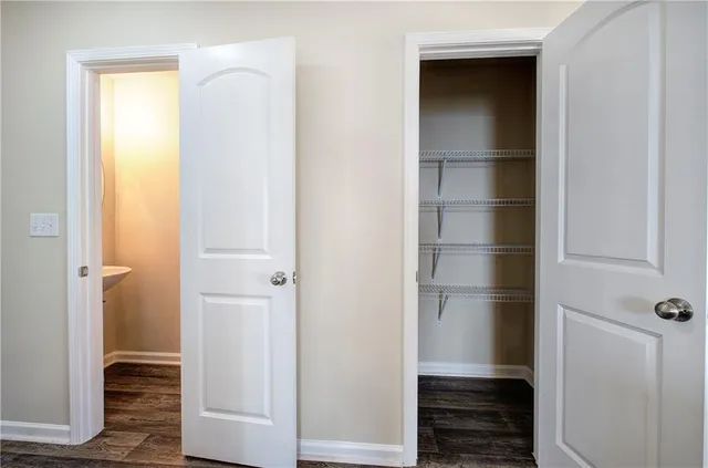 a view of walk in closet with empty racks