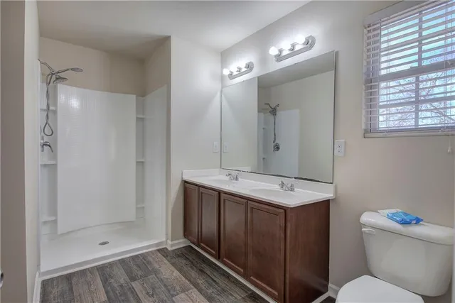 a bathroom with a sink toilet and shower